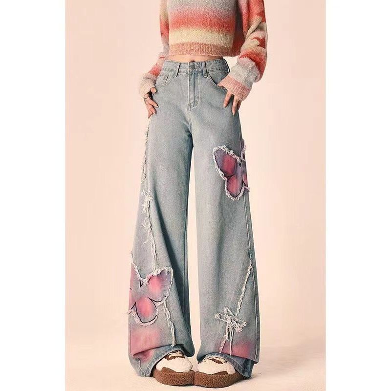 Jeans tie-dye con farfalle a vita alta ed effetto slanciante, stile grintoso